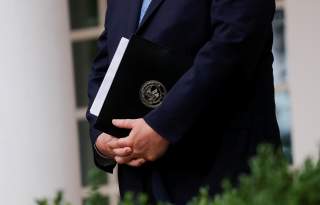 U.S. Attorney General Bill Barr stands with a copy of his remarks in his hands before announcing the Trump administration's effort to gain citizenship data during the 2020 census at an event with the president in the Rose Garden of the White House