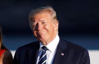 U.S. President Donald Trump and first lady Melania Trump smile during the family photo session with invited guests at the G7 summit in Biarritz, France August 25, 2019. REUTERS/Christian Hartmann/Pool