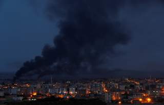 Smoke rises over the Syrian town of Ras al Ain, as seen from the Turkish border town of Ceylanpinar, in Sanliurfa province, Turkey, October 16. REUTERS/Murad Sezer