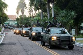 Members of a special unit of the Mexican Army leave a military zone to patrol as part of an operation to increase security after cartel gunmen clashed with federal forces, resulting in the release of Ovidio Guzman from detention, the son of drug kingpin