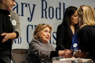 FILE PHOTO: Hillary Clinton talks to a supporter during a signing event for 