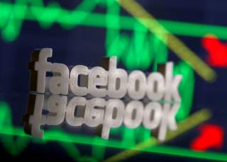A 3D-printed Facebook logo is seen in front of displayed stock graph in this illustration photo, March 20, 2018. Picture taken March 20. REUTERS/Dado Ruvic