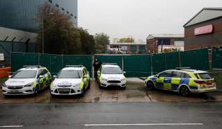 Police vehicles are seen at the scene where bodies were discovered in a lorry container, in Grays, Essex, Britain October 24, 2019. REUTERS/Simon Dawson