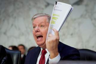 U.S. Senate Judiciary Committee Chairman Senator Lindsey Graham (R-SC) holds a copy of an intelligence report on the Steele dossier as he delivers an opening statement prior to hearing testimony from Justice Department Inspector General Michael Horowitz