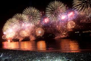 People watch as fireworks explode over Copacabana beach during New Year celebrations in Rio de Janeiro, Brazil January 1, 2020. REUTERS/Ueslei Marcelino