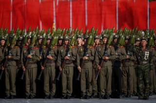 Soldiers carry rocket launchers in front of a stand with North Korean leader Kim Jong Un and other officials during the parade celebrating the 70th anniversary of the founding of the ruling Workers' Party of Korea, in Pyongyang October 10, 2015. Isolated 