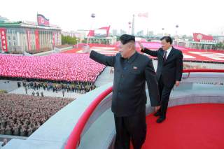 North Korean leader Kim Jong Un (L) and senior Chinese Communist Party official Liu Yunshan (R) wave during celebration of the 70th anniversary of the founding of the ruling Workers' Party of Korea, in this undated photo released by North Korea's Korean C