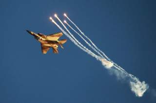 An Israeli air force F-15I fighter jet releases flares during an air force pilots' graduation ceremony at Hatzerim air base in southern Israel June 27, 2013. Some 30 cadets graduated on Thursday where they were addressed by Israel's Prime Minister Benjami