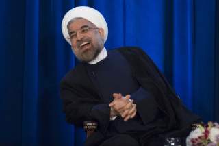 Iran's President Hassan Rouhani laughs as he speaks during an event hosted by the Council on Foreign Relations and the Asia Society in New York, September 26, 2013. REUTERS/Keith Bedford