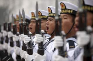 Chinese People's Liberation Army Navy recruits chant slogan during a parade to mark the end of a semester at a military base of the North Sea Fleet, in Qingdao, Shandong province December 5, 2013. REUTERS/China Daily 