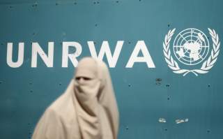 A Palestinian woman takes part in a protest against possible reductions of the services and aid offered by United Nations Relief and Works Agency (UNRWA), in front of UNRWA headquarters in Gaza City August 16, 2015. REUTERS/Mohammed Salem