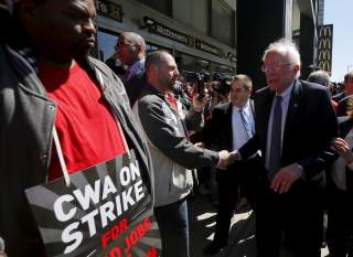 U.S. Democratic presidential candidate and U.S. Senator Bernie Sanders greets Communications Workers of America (CWA) workers striking against Verizon in Brooklyn, New York April 13, 2016. REUTERS/Brian Snyder