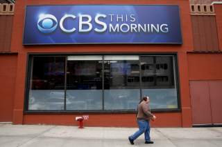 A man walks past the CBS News studios at the CBS Broadcast Center on West 57th St. in Manhattan, New York, U.S., April 29, 2016. REUTERS/Brendan McDermid