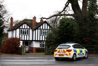 A police car drives past an address which has been linked by local media to former British intelligence officer Christopher Steele, who has been named as the author of an intelligence dossier on President-elect Donald Trump, in Wokingham, Britain, January