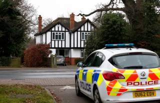 A police car drives past an address which has been linked by local media to former British intelligence officer Christopher Steele, who has been named as the author of an intelligence dossier on President-elect Donald Trump, in Wokingham, Britain