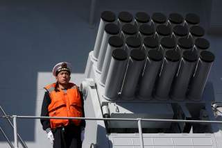 A Chinese serviceman stands beside a multibarrel rocket launcher on the deck of a naval vessel, upon its arrival to participate in Pakistan Navy’s Multinational Exercise AMAN-17, in Karachi, Pakistan, February 9, 2017. REUTERS/Akhtar Soomro