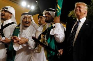 Saudi Arabia's King Salman bin Abdulaziz Al Saud (2nd L) welcomes U.S. President Donald Trump to dance with a sword during a welcome ceremony at Al Murabba Palace in Riyadh, Saudi Arabia May 20, 2017. REUTERS/Jonathan Ernst