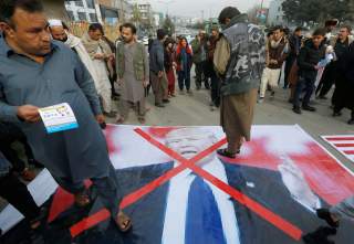 Demonstrator step onto a poster of U.S. President Donald Trump during a protest against U.S. President Donald Trump's recognition of Jerusalem as Israel's capital, in Kabul, Afghanistan, December 8, 2017 REUTERS/Omar Sobhani