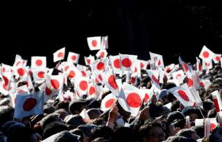 Well-wishers wave Japanese national flags as Japan's Emperor Akihito (not pictured) appears on a balcony of the Imperial Palace during a public appearance for New Year celebrations at the Imperial Palace in Tokyo, Japan, January 2, 2018. REUTERS/Toru Hana