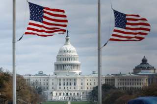 American flags fly on National Mall with U.S. Capitol on background as high-wind weather conditions continue in Washington, U.S. March 2, 2018. REUTERS/Yuri Gripas
