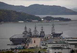 Japan Maritime Self-Defense Force's (JMSDF) latest Izumo-class helicopter carrier DDH-184 Kaga (L) and other JMSDF destroyers DD-157 Sawagari, DDG-176 Chokai, DD-104 Kirisame and DDH-182 Ise are moored at a naval base in Sasebo, on the southwest island of