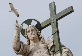 A seagull flies next to the statue of Jesus Christ during Pope Francis' Wednesday general audience in Saint Peter's square at the Vatican, April 18, 2018. REUTERS/Max Rossi