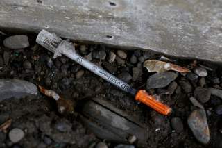 A discarded syringe is seen under a bridge on Lester Avenue in Johnson City, New York, U.S., April 7, 2018. Picture taken April 7, 2018. REUTERS/Andrew Kelly