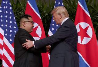 U.S. President Donald Trump shakes hands with North Korean leader Kim Jong Un at the Capella Hotel on Sentosa island in Singapore June 12, 2018. REUTERS/Jonathan Ernst TPX IMAGES OF THE DAY