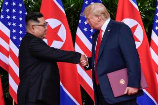 U.S. President Donald Trump and North Korea's leader Kim Jong Un shake hands during the signing of a document after their summit at the Capella Hotel on Sentosa island in Singapore June 12, 2018. Susan Walsh/Pool via Reuters