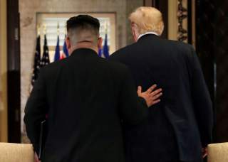 U.S. President Donald Trump and North Korea's leader Kim Jong Un leave after signing documents that acknowledge the progress of the talks and pledge to keep momentum going, after their summit at the Capella Hotel on Sentosa island in Singapore June 12, 20