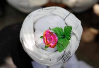 An artificial flower is seen on a turban of a peace marcher as he arrives in Kabul, Afghanistan June 18, 2018. REUTERS/Mohammad Ismail