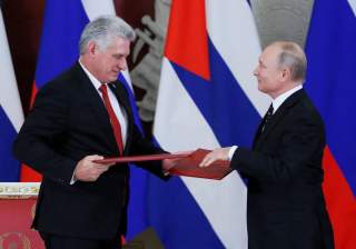 Russian President Vladimir Putin and Cuban President Miguel Diaz-Canel exchange documents following their meeting at the Kremlin in Moscow, Russia November 2, 2018. REUTERS/Maxim Shemetov