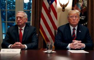 FILE PHOTO: U.S. President Donald Trump speaks to the news media while gathering for a briefing from his senior military leaders, including Defense Secretary James Mattis (L), in the Cabinet Room at the White House in Washington, U.S., October 23, 2018. R