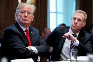 U.S. President Donald Trump listens next to Acting U.S. Defense Secretary Patrick Shanahan during a Cabinet meeting on day 12 of the partial U.S. government shutdown at the White House in Washington, U.S., January 2, 2019. REUTERS/Jim Young