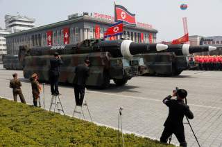 FILE PHOTO: Missiles are driven past the stand with North Korean leader Kim Jong Un and other high ranking officials during a military parade marking the 105th birth anniversary of the country's founding father Kim Il Sung, in Pyongyang April 15, 2017. RE