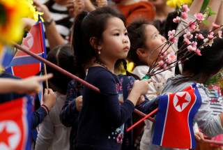 Children wait for the motorcade carrying North Korea's leader Kim Jong Un to pass, in Hanoi, Vietnam, March 1, 2019. REUTERS/Jorge Silva