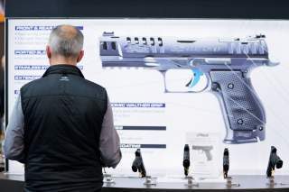 A man inspects handguns inside of the Walther booth during the National Rifle Association (NRA) annual meeting in Indianapolis, Indiana, U.S., April 28, 2019. REUTERS/Lucas Jackson