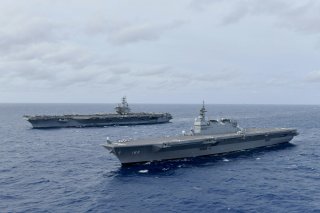 The Navy's forward-deployed aircraft carrier USS Ronald Reagan operates with the Japan Maritime Self-Defense Force helicopter carrier JS Izumo (R) in South China Sea June 11, 2019. Picture taken June 11, 2019. Courtesy JMSDF/U.S. Navy/Handout via REUTERS