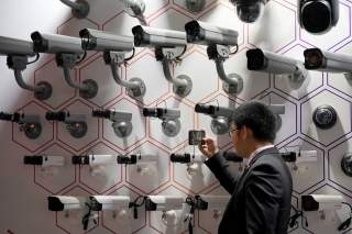 A man looks at surveillance cameras at the annual Huawei Connect event in Shanghai, China September 18, 2019. REUTERS/Aly Song