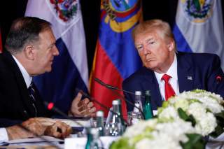 U.S. President Donald Trump confers with U.S. Secretary of State Mike Pompeo during a multilateral meeting with Western Hemisphere leaders about Venezuela during the 74th session of the United Nations General Assembly (UNGA) at U.N. headquarters.