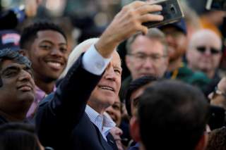 Democratic presidential candidate and former Vice President Joe Biden takes selfies with supporters at a 