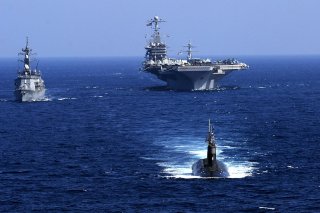 The Seawolf-class submarine USS Seawolf (SSN 21), leads the Japan Maritime Self-Defense Force destroyer JS Oonami (DD 111), left, and the Nimitz-class aircraft carrier USS John C. Stennis (CVN 74) after a successful undersea warfare exercise involving the