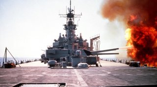 The battleship USS WISCONSIN (BB-64) fires a round from one of the Mark 7 16-inch/50-caliber guns in its No. 3 turret during Operation Desert Storm. 6 February 1991. U.S. Navy/John Carnes.