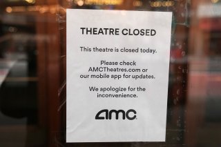 A sign is displayed on the window of a movie theater in Times Square following the outbreak of coronavirus disease (COVID-19), in the Manhattan borough of New York City, New York, U.S. March 17, 2020. REUTERS/Carlo Allegri