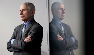 National Institute of Allergy and Infectious Diseases Director Dr. Anthony Fauci is reflected in a video monitor behind him on stage as he listens to the daily coronavirus task force briefing at the White House in Washington, U.S., April 8, 2020. REUTERS/