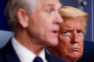 U.S. President Donald Trump listens as White House Director of Trade and Marketing Policy Peter Navarro addresses the daily coronavirus response briefing at the White House in Washington, U.S., April 2, 2020. REUTERS/Tom Brenner