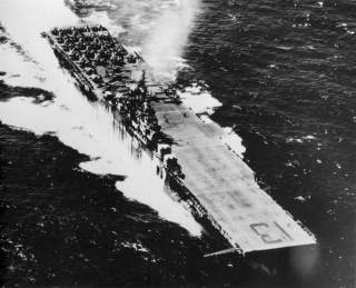 The U.S. Navy aircraft carrier USS Franklin (CV-13) underway with aircraft of Carrier Air Group 13 (CVG-13) on deck. Between May 1944 and November 1944, Franklin was the only carrier wearing two different camouflage schemes, Measure 32 Design 3A on the po