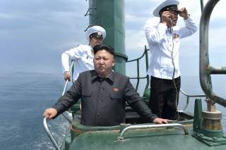 North Korean leader Kim Jong Un stands on the conning tower of a submarine during his inspection of the Korean People's Army Naval Unit 167 in this undated photo released June 16, 2014. 
