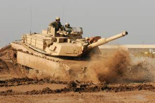 An Iraqi Army tanker with the 9th Armored Division drives an M1A1 Abrams tank under the instruction of Soldiers with Company C, 1st Battalion, 18th Infantry Regiment, 2nd Advise and Assist Brigade, 1st Infantry Division, United States Division-Center Jan.