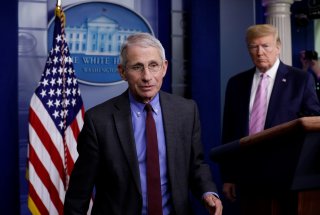 National Institute of Allergy and Infectious Diseases director Dr. Anthony Fauci turns the podium over to U.S. President Donald Trump during the coronavirus response daily briefing at the White House in Washington, U.S., April 10, 2020. REUTERS/Yuri Gripa